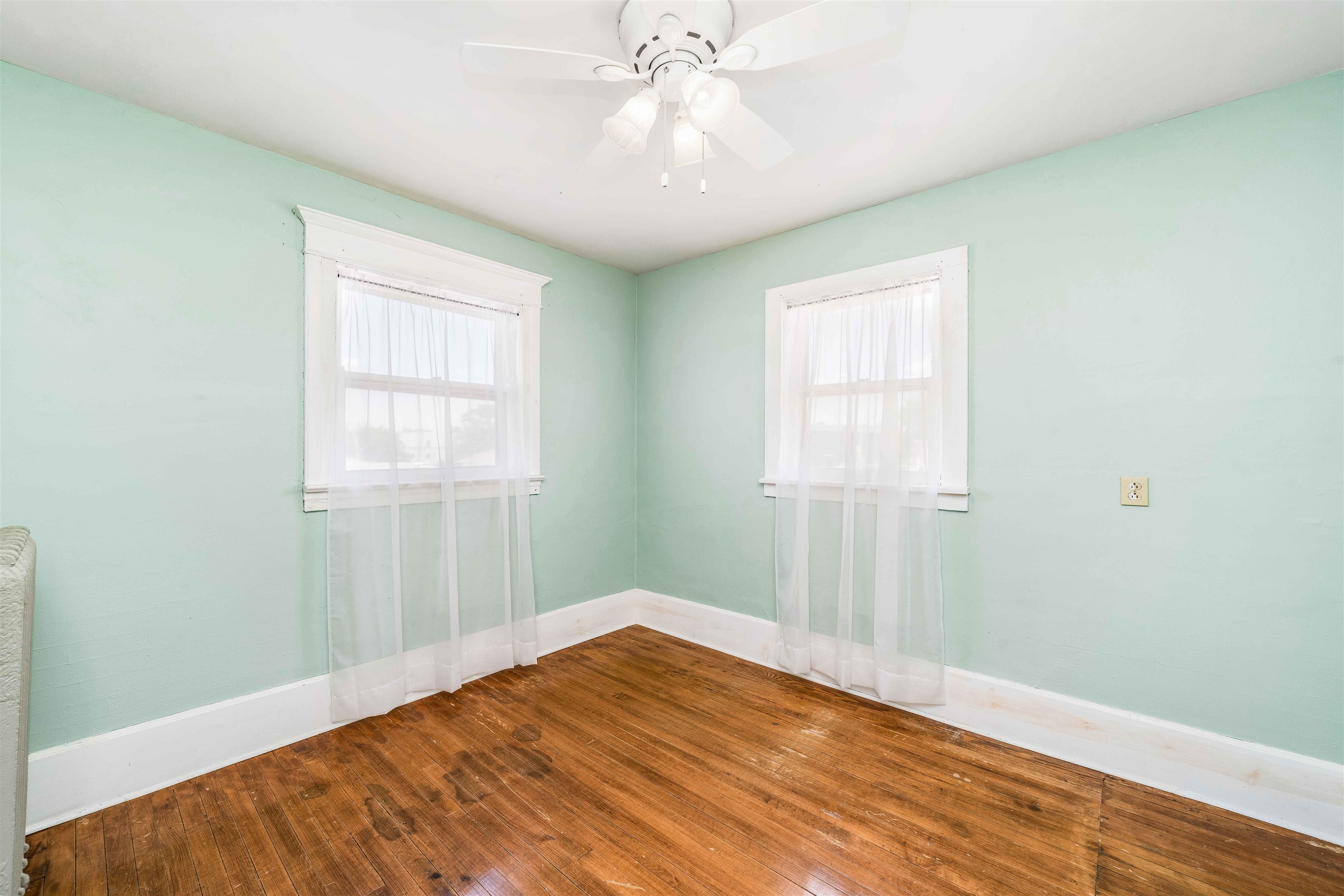 111 South Sycamore Street Genoa, IL 60135 - Photo 8 of 22 an empty room with chandelier fan and windows