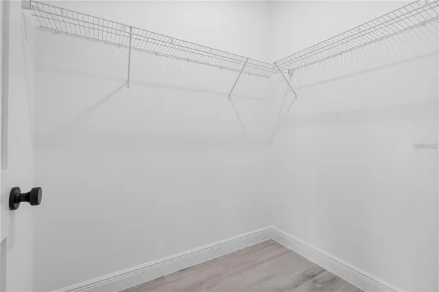 a bathroom with a toilet a sink a mirror and shower