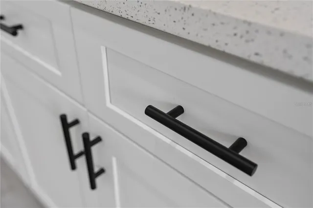 a view of a kitchen with stainless steel appliances refrigerator wooden floor and a window
