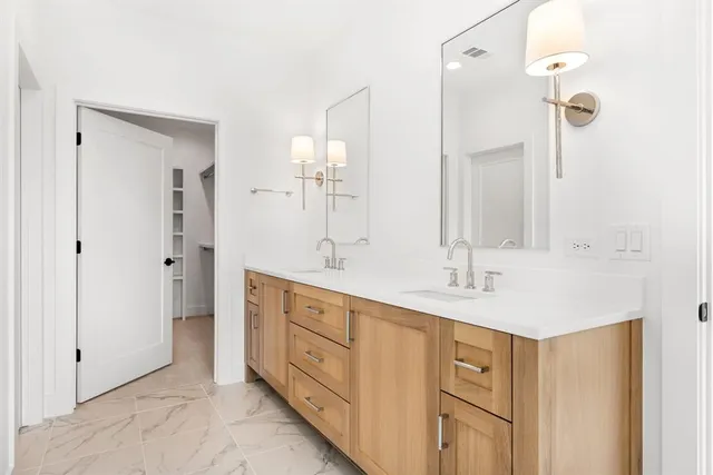 a bathroom with a tub sink and mirror