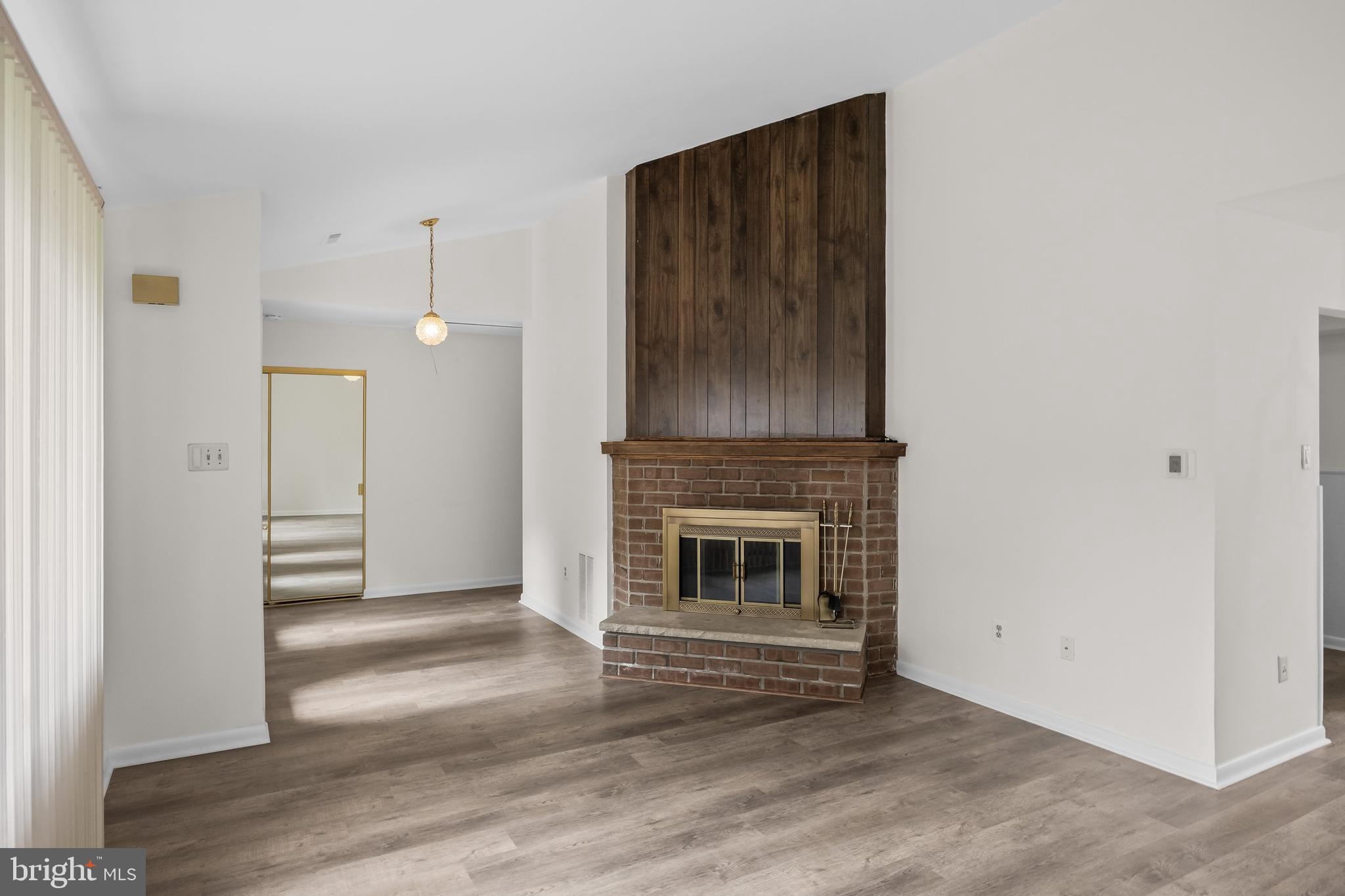 367 Barton Run Boulevard Marlton, NJ 08053 - Photo 6 of 24 an empty room with wooden floor a fireplace and windows