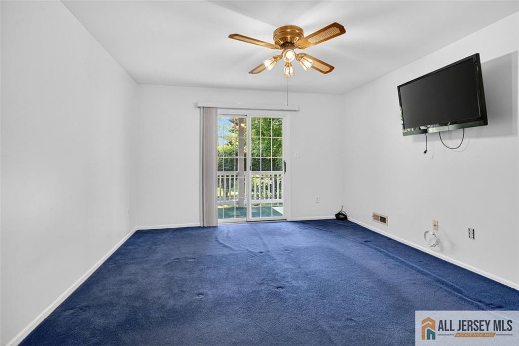 40C Rutland Lane, Unit 40B Monroe Township, NJ 08831 - Photo 19 of 37 an empty room with a flat screen tv