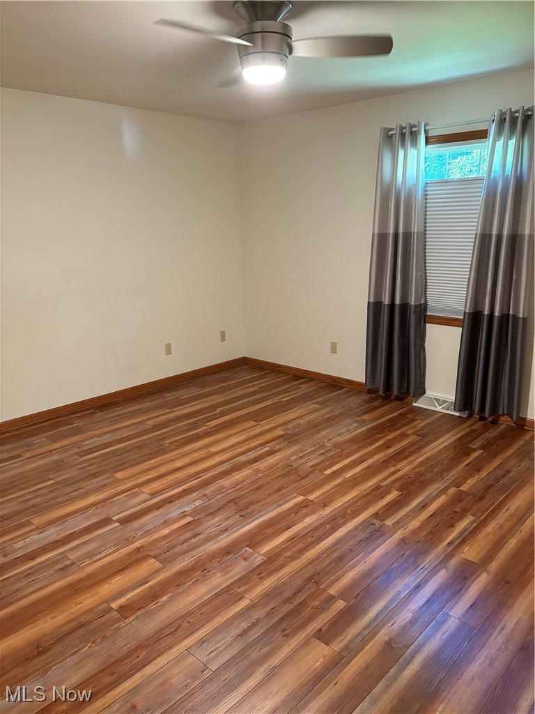 6695 Clingan Road, Unit 24 Youngstown, OH 44514 - Photo 11 of 26 Spare room with dark wood finished floors and ceiling fan