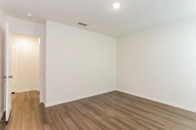 a view of a room with wooden floor
