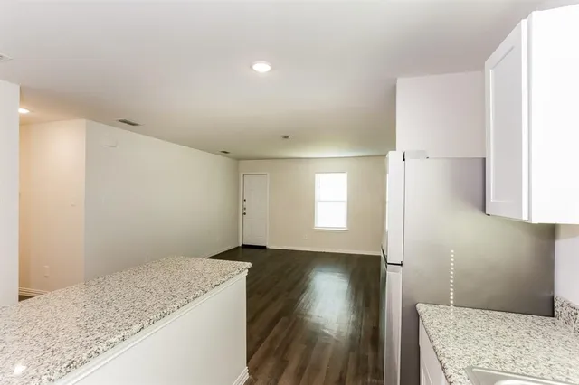 a view of hallway with wooden floor