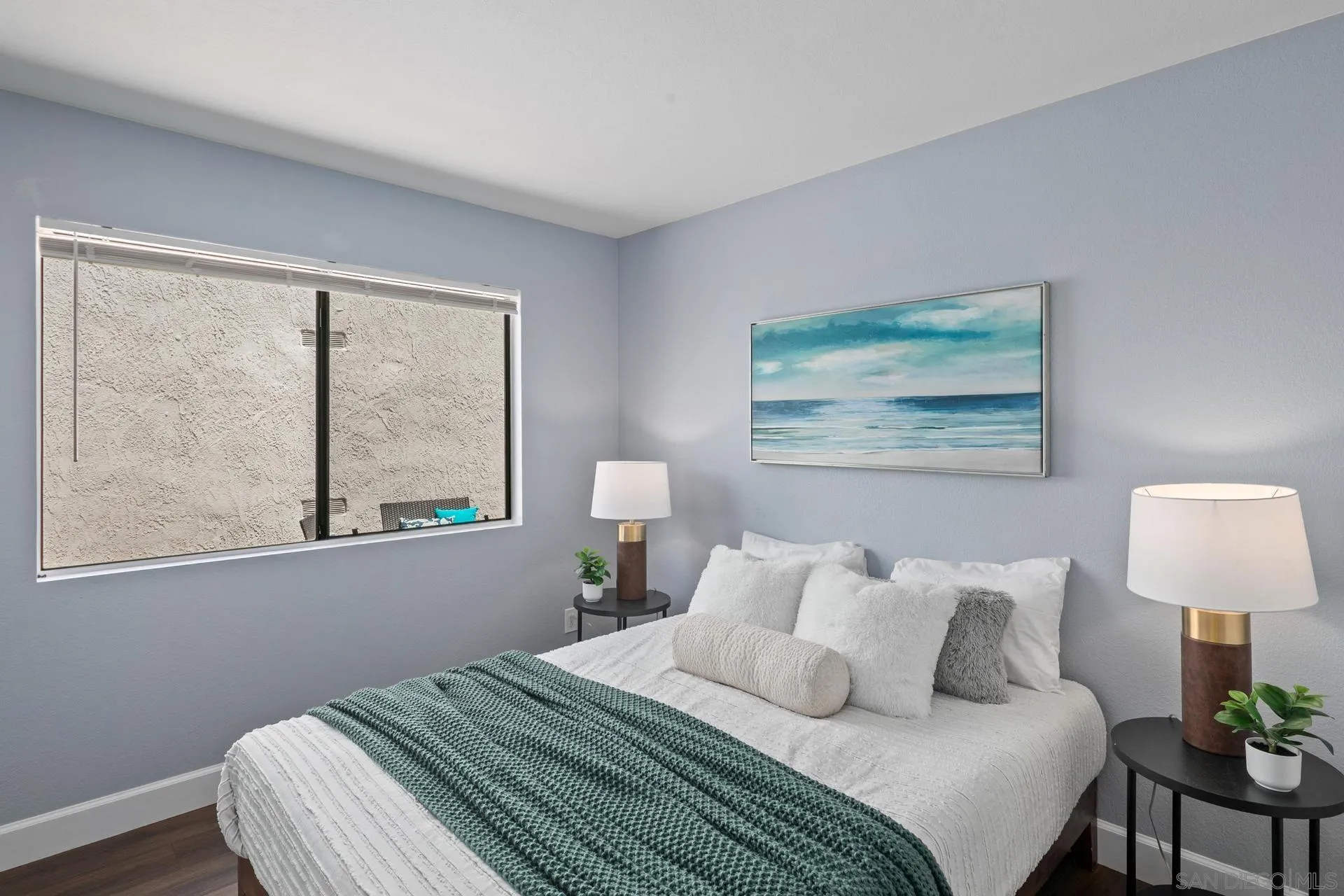 802 Spindrift Lane Carlsbad, CA 92011 - Photo 15 of 31 a bedroom with a bed and a lamp on table