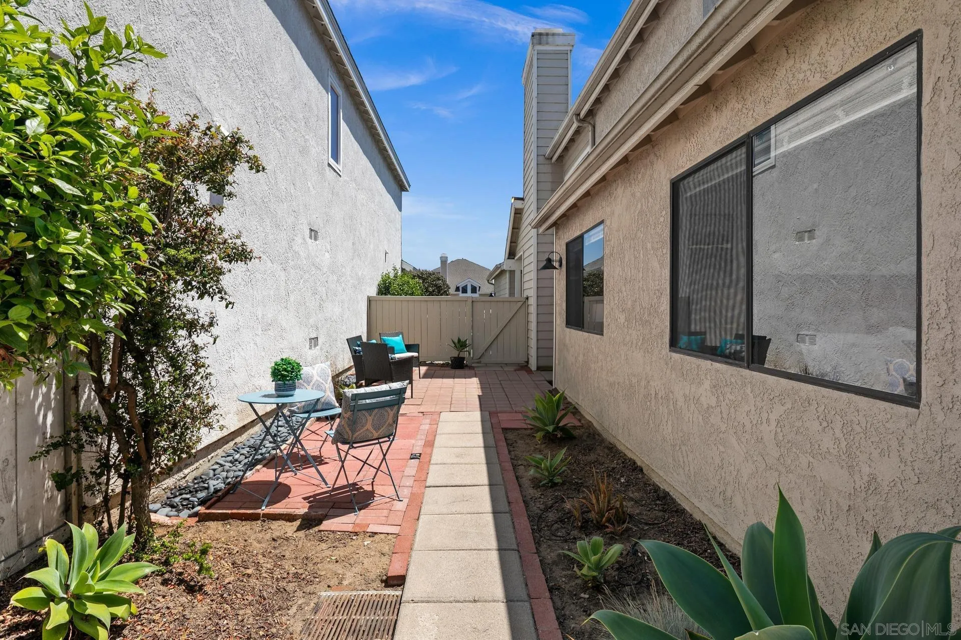 802 Spindrift Lane Carlsbad, CA 92011 - Photo 25 of 31 a view of a patio with table and chairs potted plants with wooden floor
