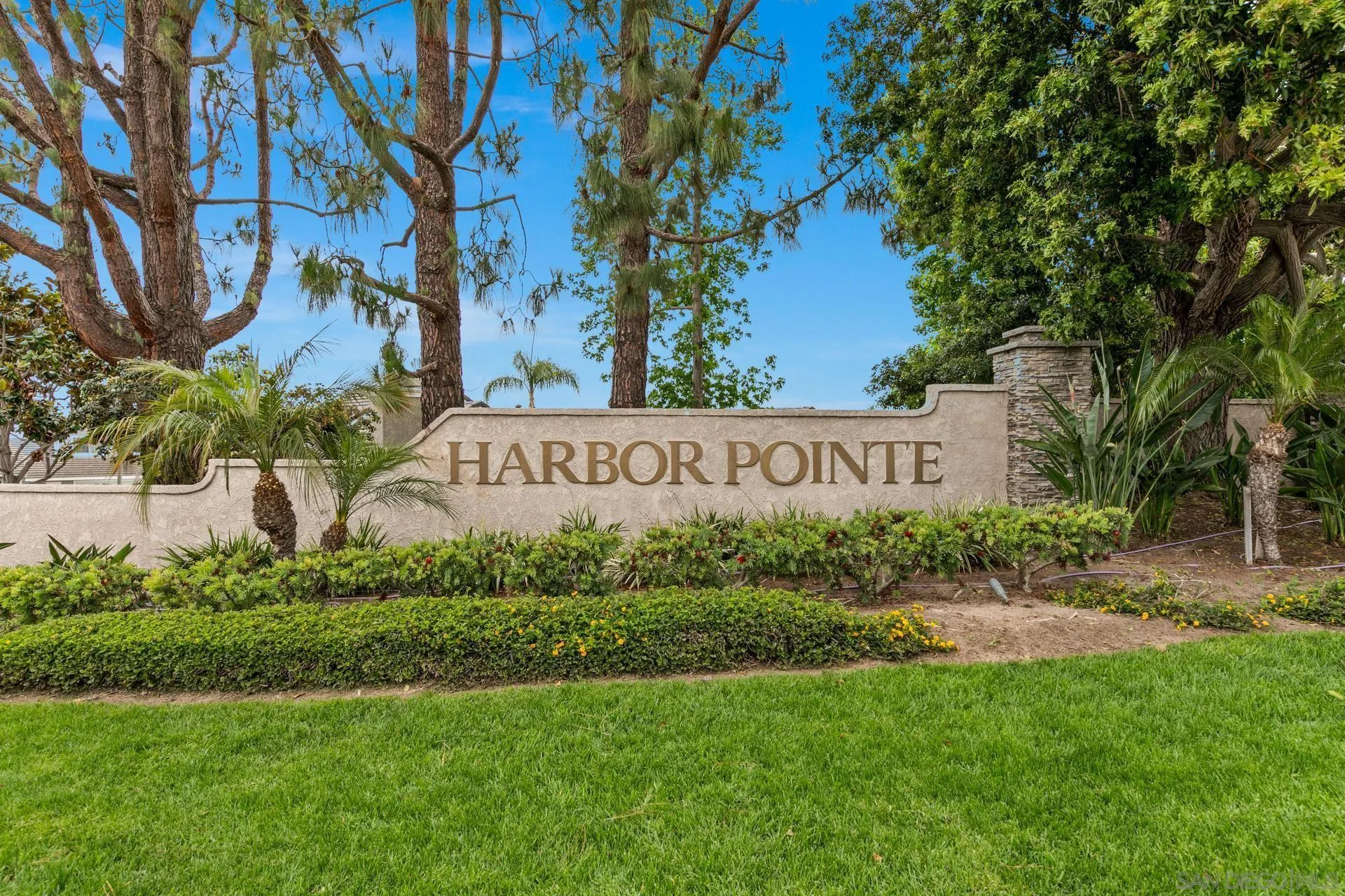 802 Spindrift Lane Carlsbad, CA 92011 - Photo 30 of 31 a sign of golf club on a wall under a tree