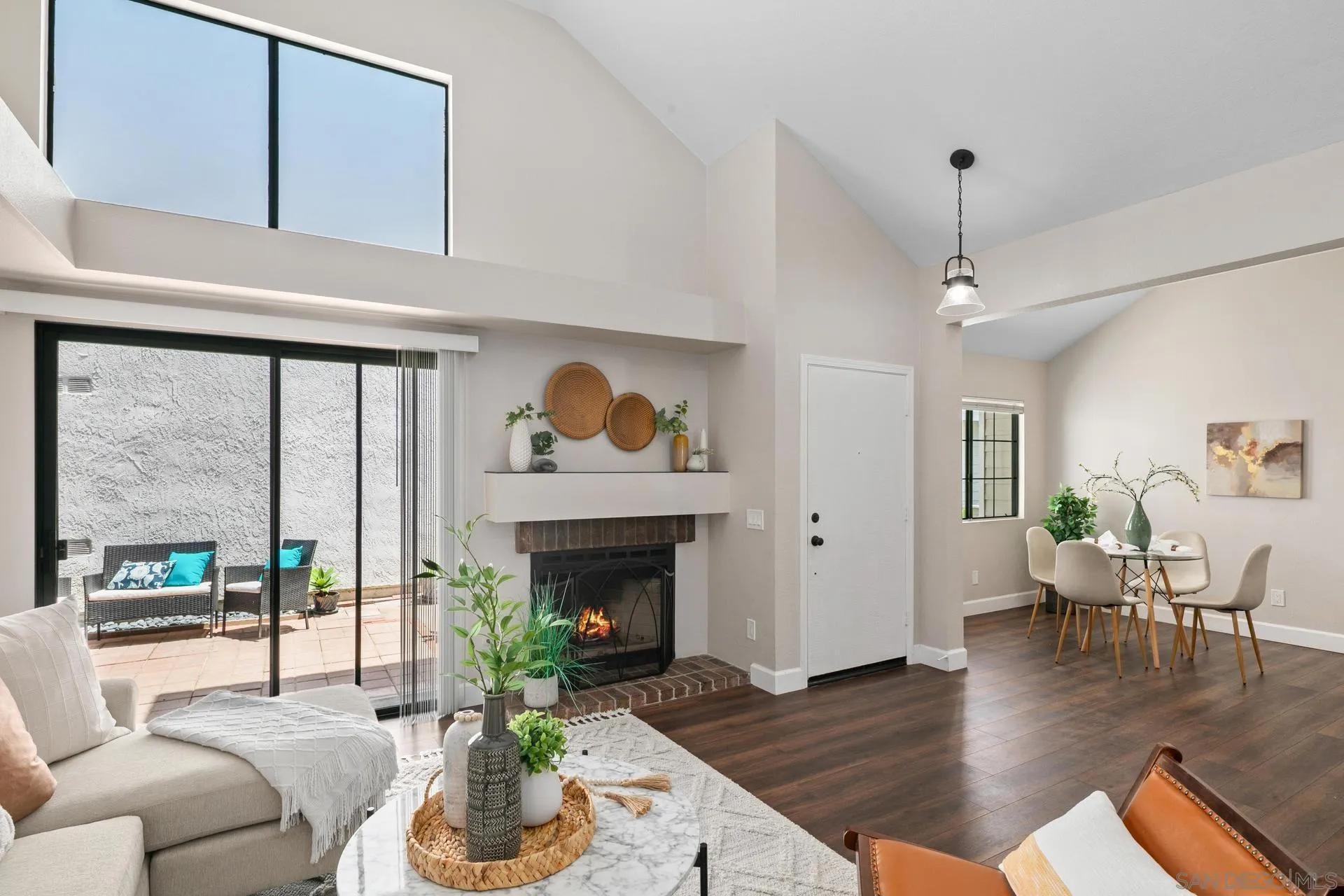802 Spindrift Lane Carlsbad, CA 92011 - Photo 3 of 31 a living room with furniture large window and a fireplace