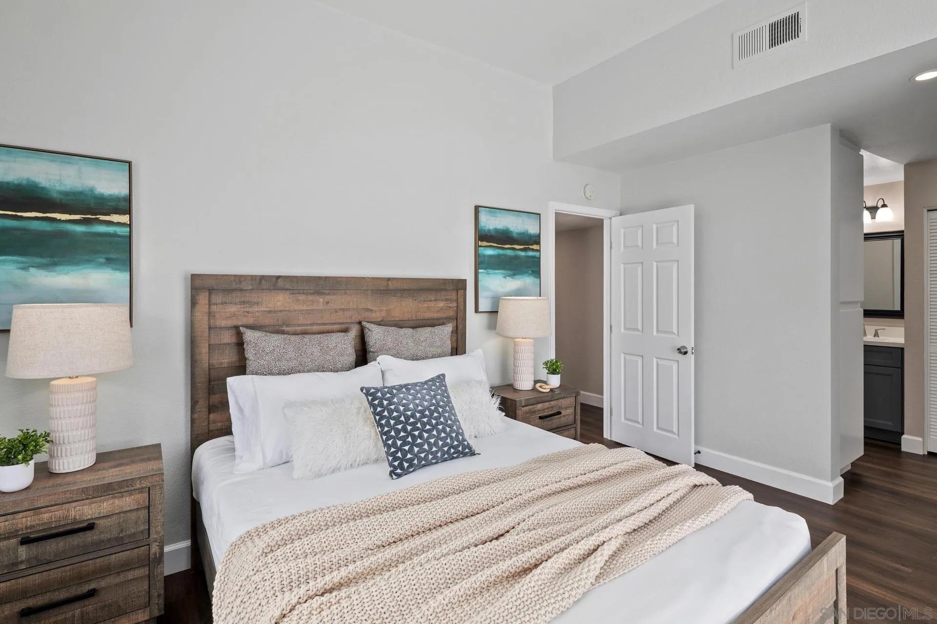 802 Spindrift Lane Carlsbad, CA 92011 - Photo 10 of 31 a bedroom with a bed and a lamp