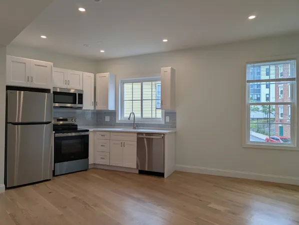 a kitchen with a refrigerator stove and microwave
