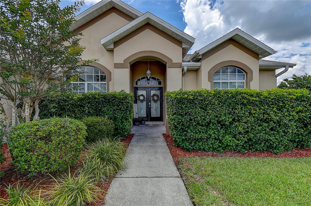 7850 Portrait Court New Port Richey, FL 34654 - Photo 1 of 1 a front view of a house with a yard