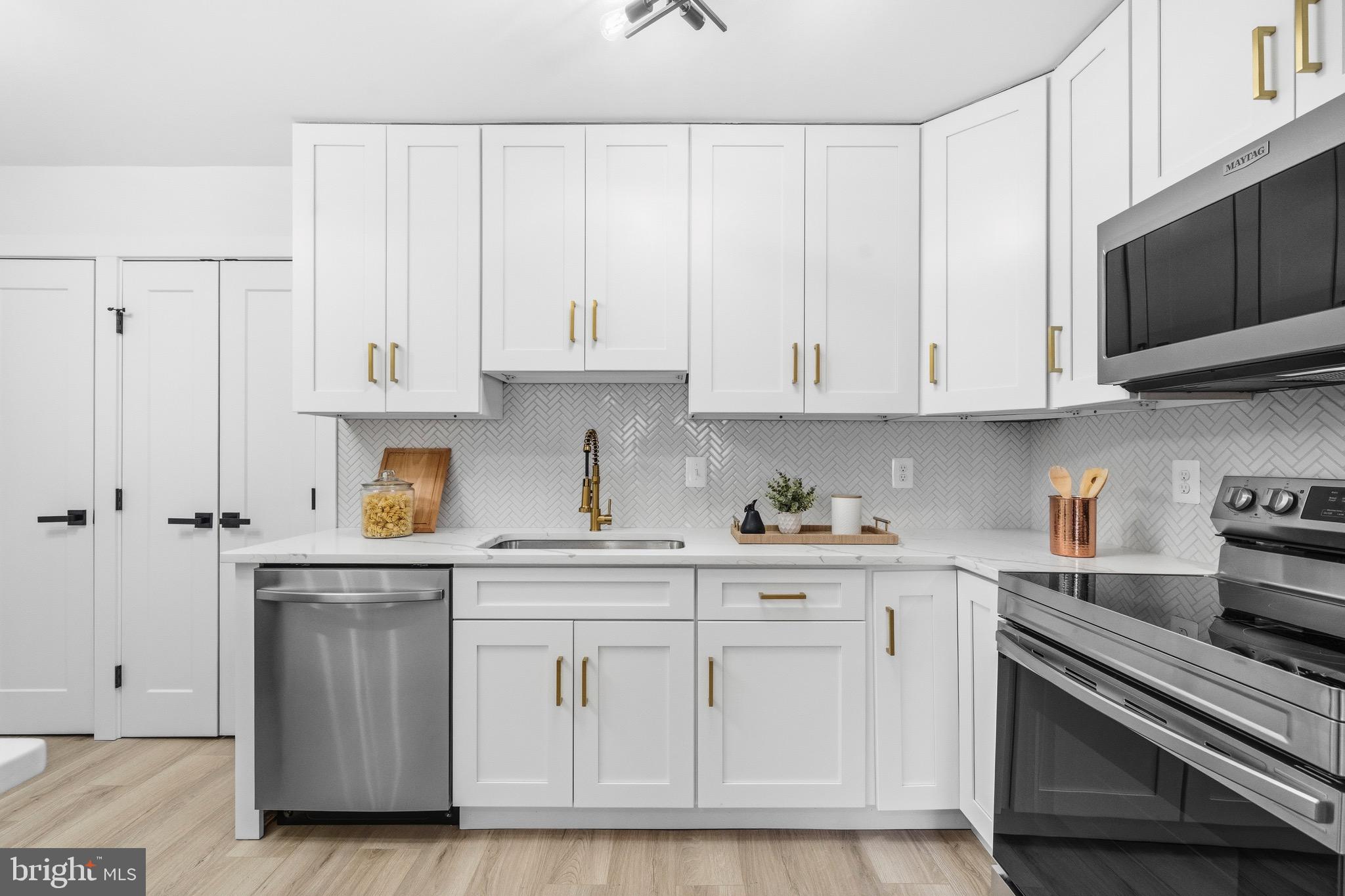 6101 Edsall Road, Unit 602 Alexandria, VA 22304 - Photo 5 of 38 a kitchen with white cabinets and sink