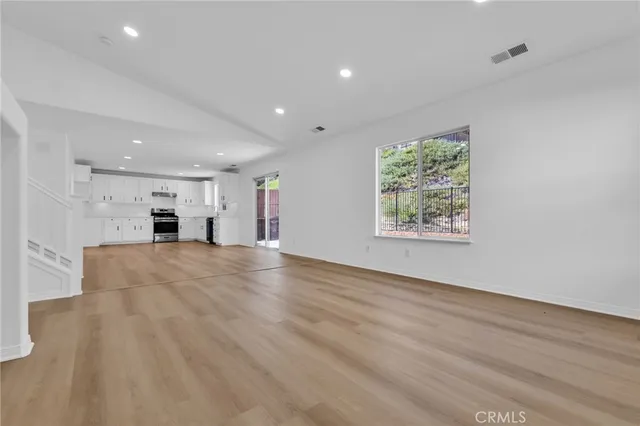 an empty room with windows and furniture