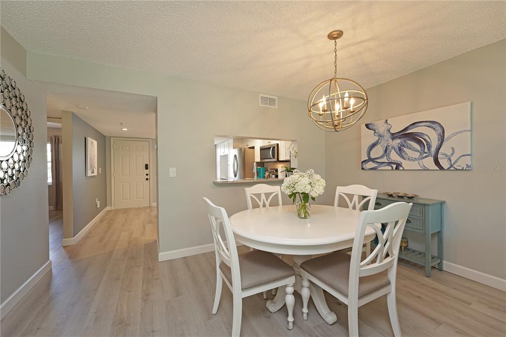 6501 Stone River Road, Unit 205 Bradenton, FL 34203 - Photo 12 of 50 a view of a dining room with furniture wooden floor and chandelier