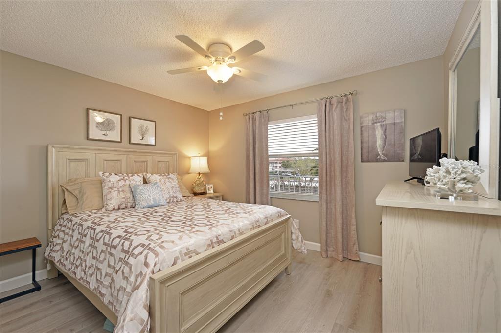 6501 Stone River Road, Unit 205 Bradenton, FL 34203 - Photo 16 of 50 a bedroom with a large bed and a chandelier