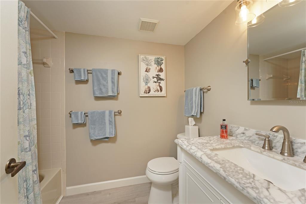 6501 Stone River Road, Unit 205 Bradenton, FL 34203 - Photo 17 of 50 a bathroom with a granite countertop sink mirror vanity and toilet