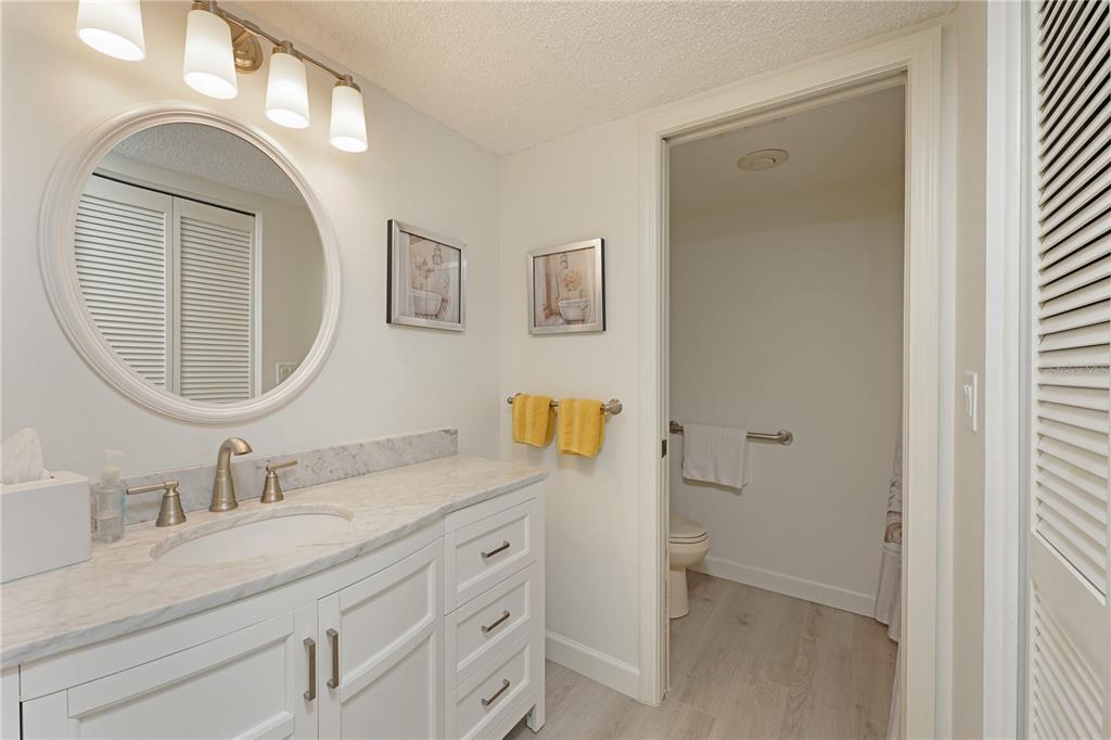 6501 Stone River Road, Unit 205 Bradenton, FL 34203 - Photo 21 of 50 a bathroom with a granite countertop sink and a mirror