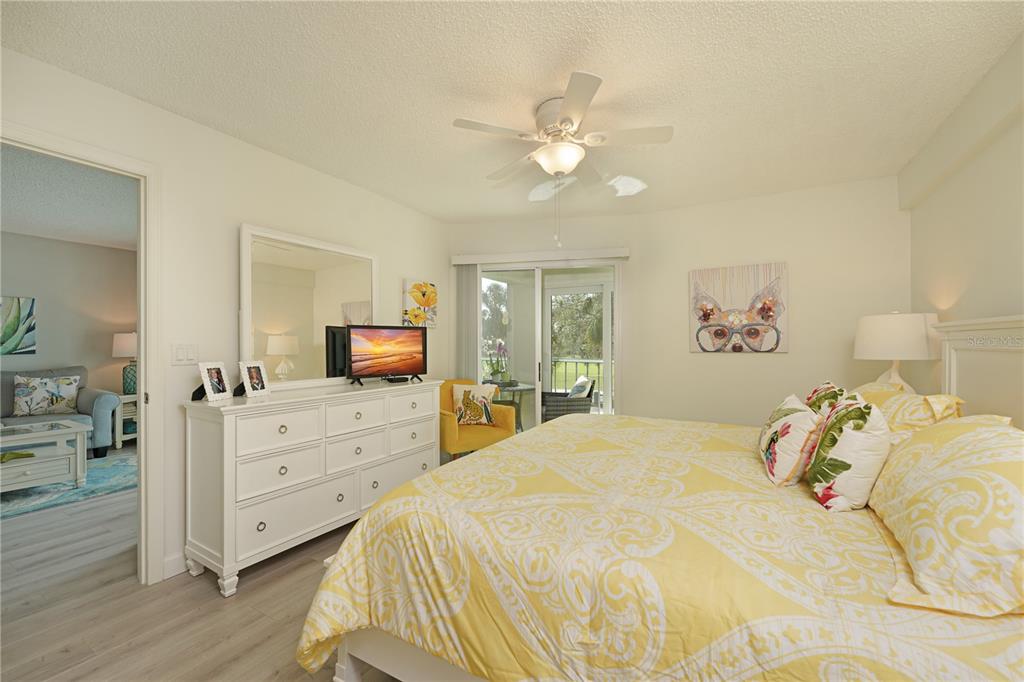 6501 Stone River Road, Unit 205 Bradenton, FL 34203 - Photo 23 of 50 a bedroom with a bed and a chandelier