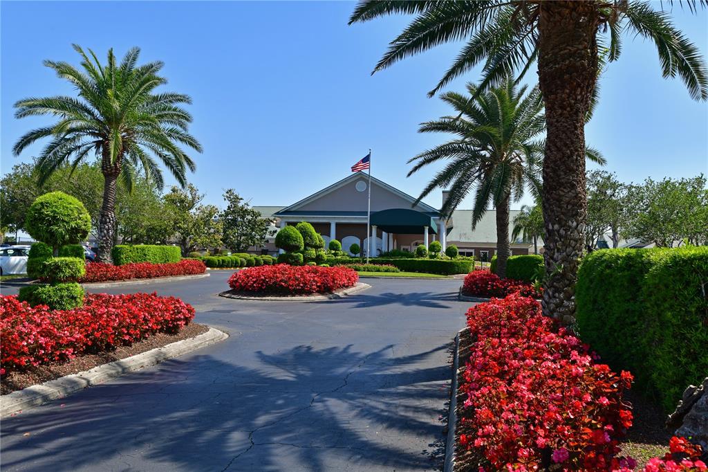 6501 Stone River Road, Unit 205 Bradenton, FL 34203 - Photo 28 of 50 a front view of a house with a yard and garden