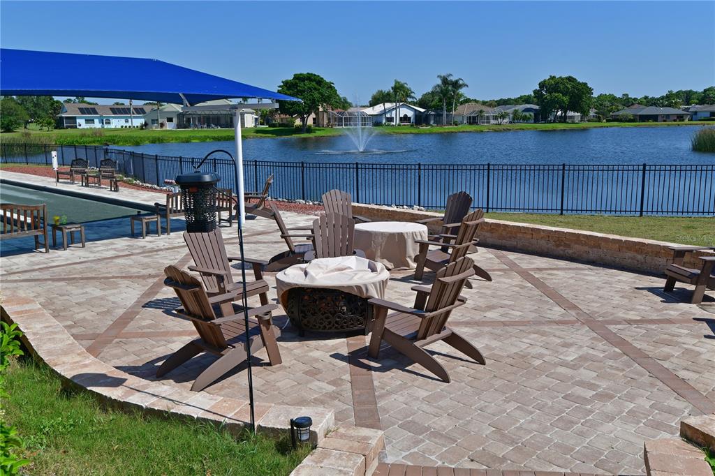 6501 Stone River Road, Unit 205 Bradenton, FL 34203 - Photo 29 of 50 a view of swimming pool with seating space and yard in the back