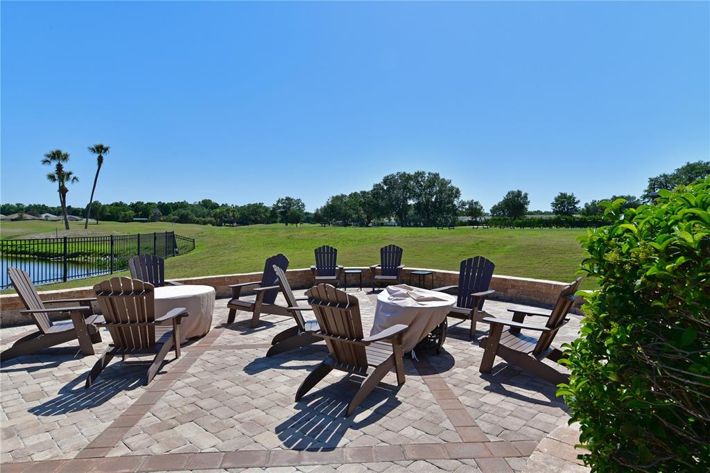 6501 Stone River Road, Unit 205 Bradenton, FL 34203 - Photo 30 of 50 a view of a patio with chairs hardwood table and chairs
