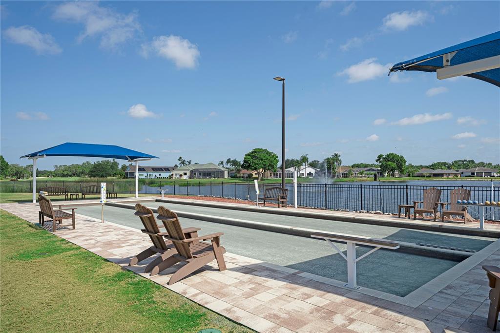 6501 Stone River Road, Unit 205 Bradenton, FL 34203 - Photo 35 of 50 a view of a swimming pool with chairs in patio
