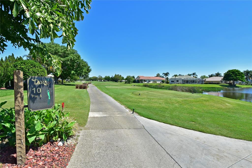 6501 Stone River Road, Unit 205 Bradenton, FL 34203 - Photo 37 of 50 a view of a garden with a building in the background