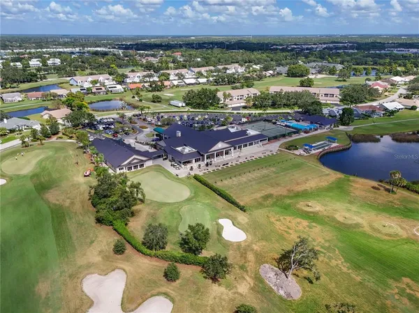 an aerial view of a house with a garden and lake view