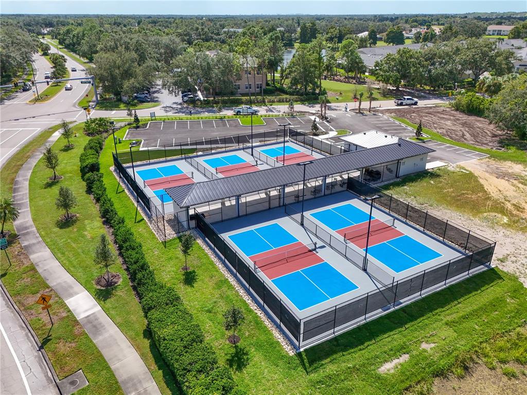 6501 Stone River Road, Unit 205 Bradenton, FL 34203 - Photo 50 of 50 an aerial view of a chairs and table in a backyard