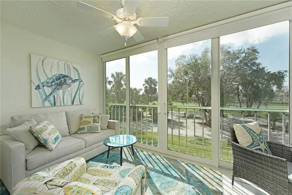a living room with furniture and a floor to ceiling window