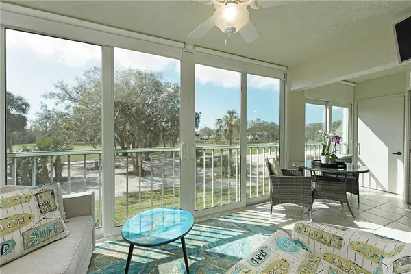 a living room with furniture and a floor to ceiling window