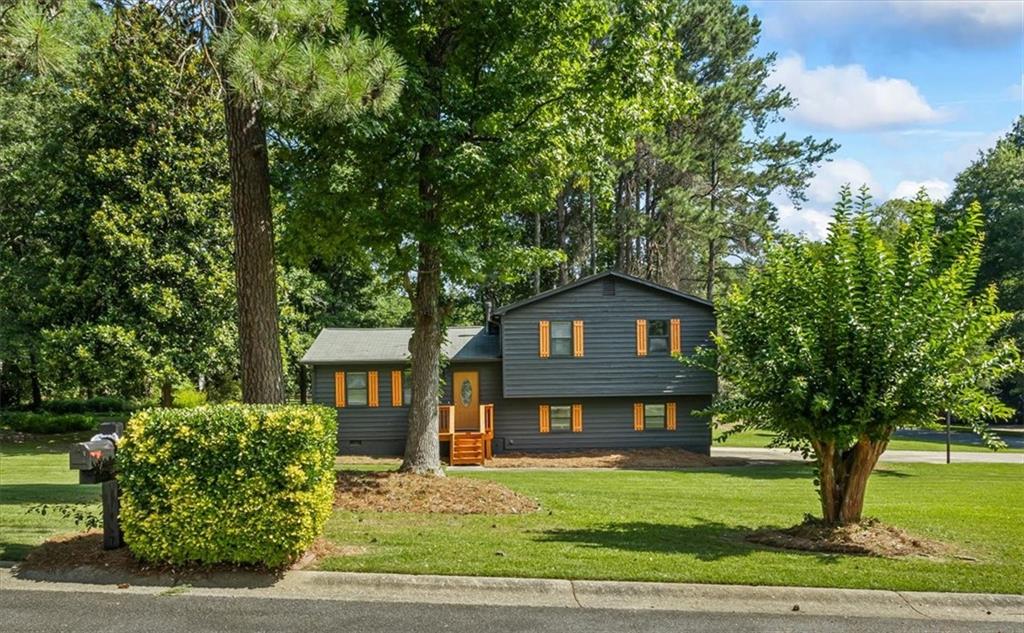 a front view of a house with a garden