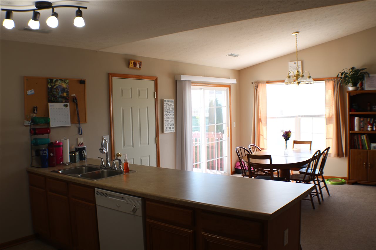 410 Pine White Road, Unit 1 Roscoe, IL 61073 - Photo 4 of 13 a view of a dining room with furniture and window