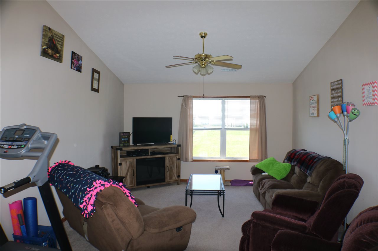 410 Pine White Road, Unit 1 Roscoe, IL 61073 - Photo 6 of 13 a living room with furniture a flat screen tv and a window
