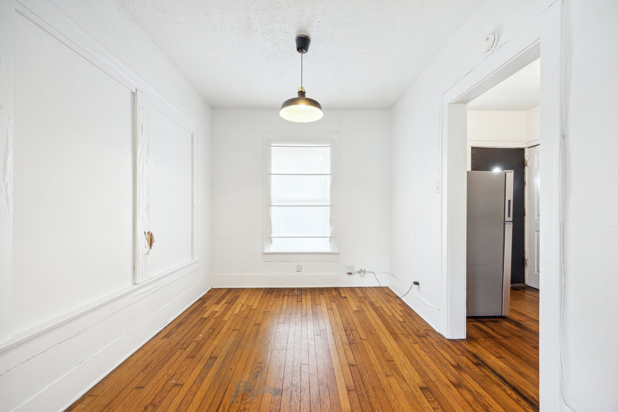 918-920 Peden Street Houston, TX 77006 - Photo 5 of 13 an empty room with wooden floor and windows