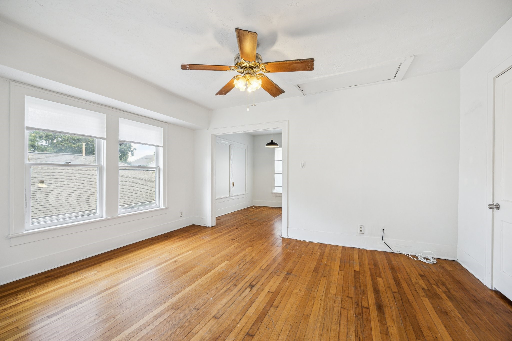 918-920 Peden Street Houston, TX 77006 - Photo 8 of 13 wooden floor in an empty room with a window