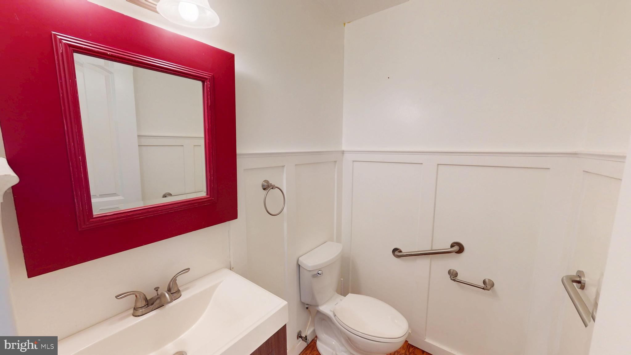 8576 Adamson Street Manassas, VA 20110 - Photo 13 of 25 a bathroom with a sink a toilet and shower