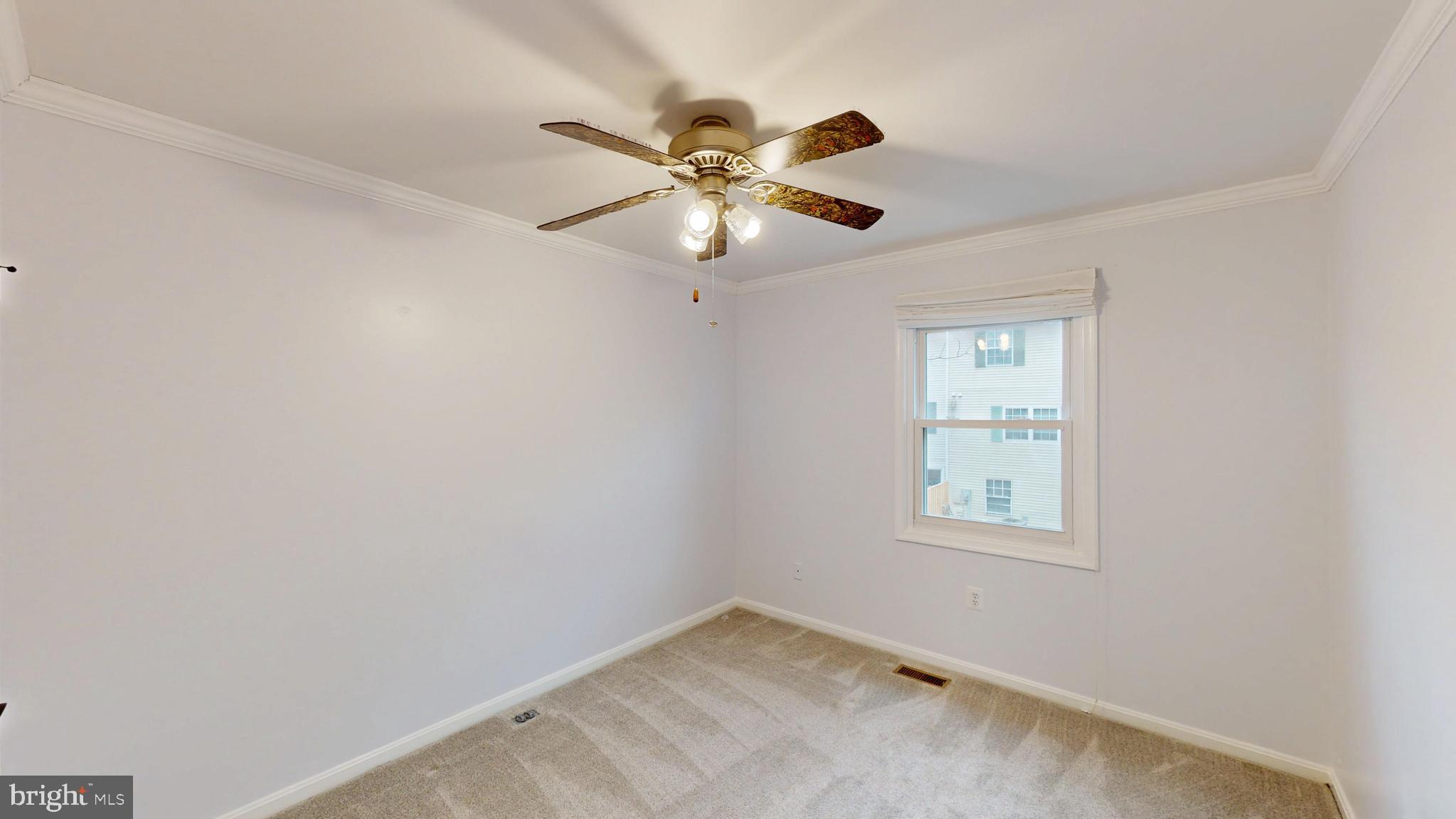 8576 Adamson Street Manassas, VA 20110 - Photo 17 of 25 an empty room with a window and a fan