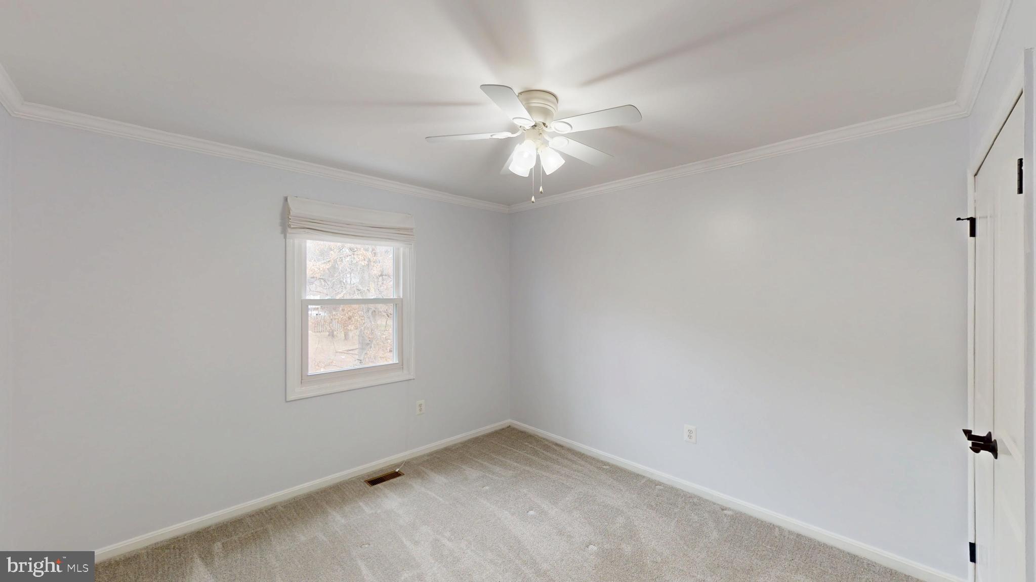 8576 Adamson Street Manassas, VA 20110 - Photo 19 of 25 an empty room with windows and fan