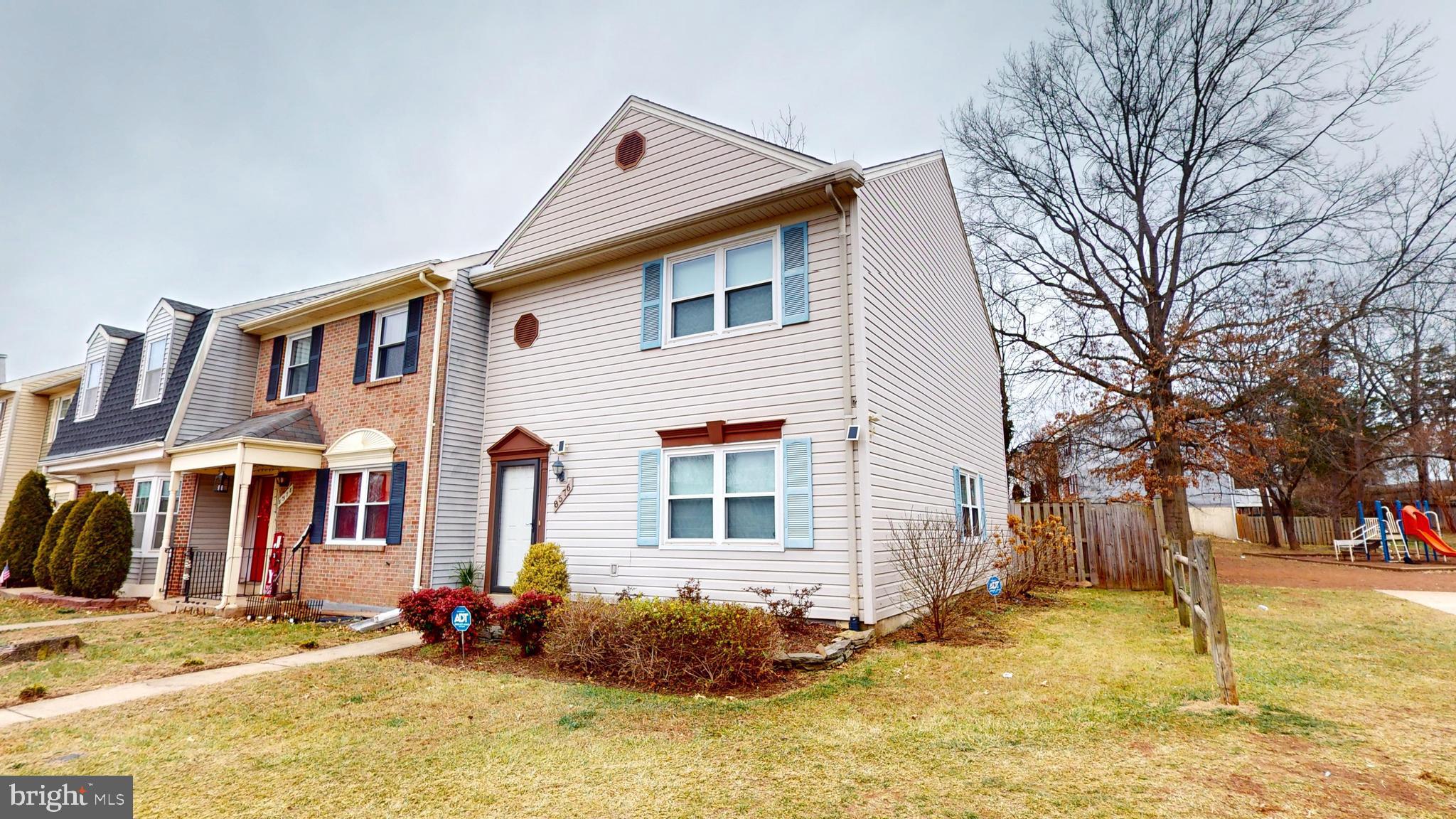 8576 Adamson Street Manassas, VA 20110 - Photo 2 of 25 a front view of a house with a yard