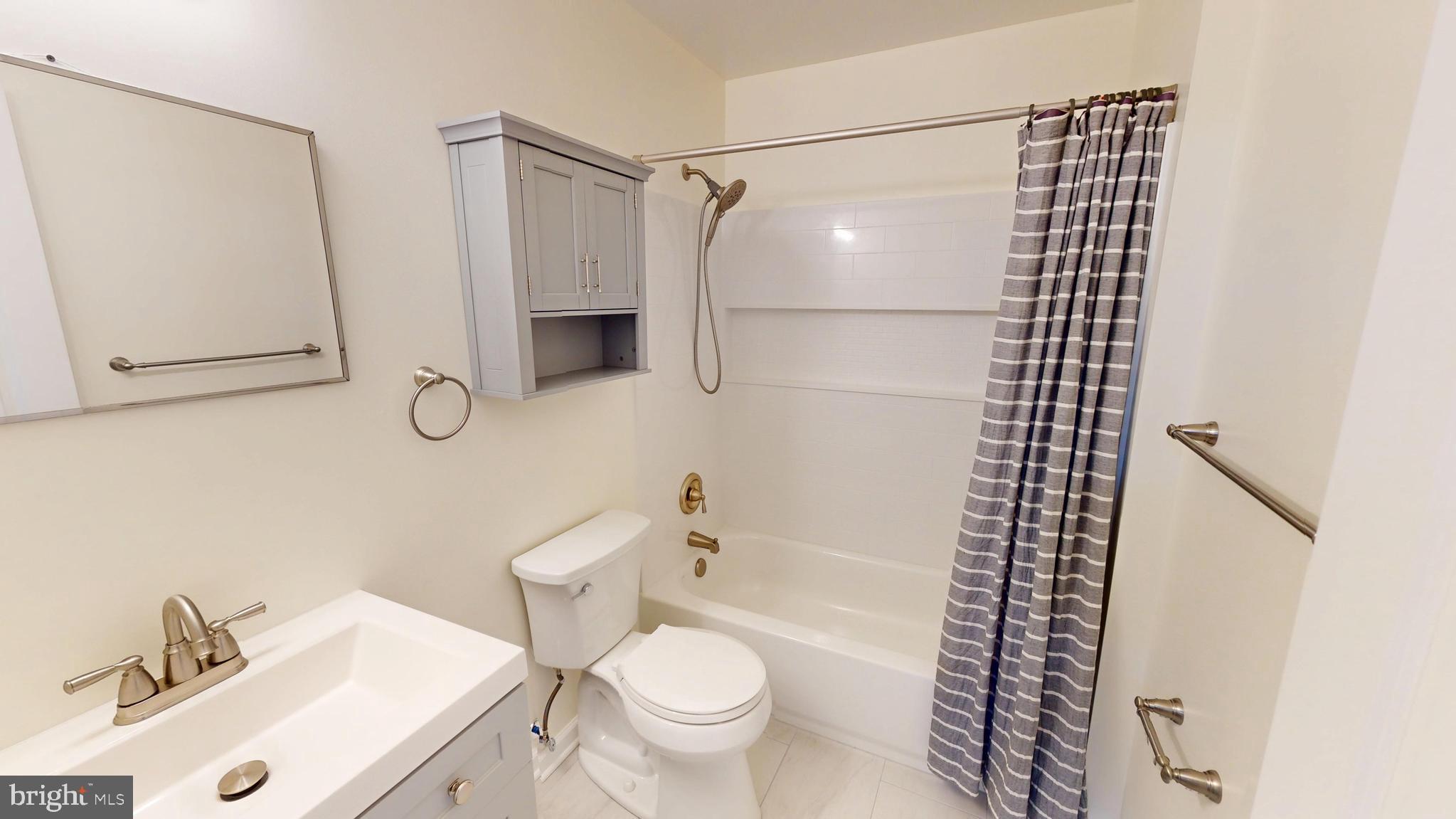 8576 Adamson Street Manassas, VA 20110 - Photo 21 of 25 a bathroom with a sink toilet and shower