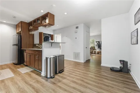 a kitchen with stainless steel appliances a refrigerator and wooden floor