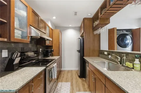 a kitchen that has a sink and a stove
