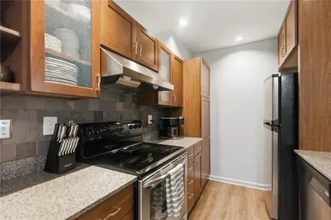a kitchen with a stove and a refrigerator