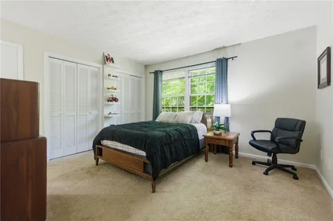 a spacious bedroom with a bed and a desk
