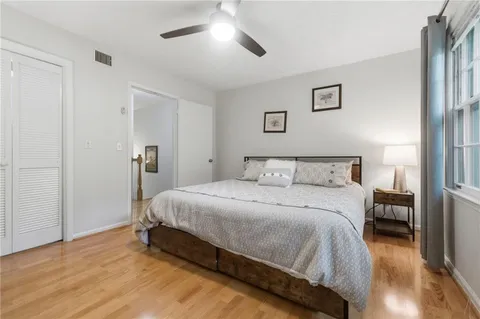 a spacious bedroom with a bed and a chandelier
