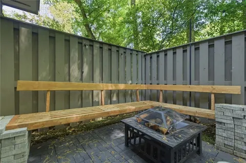a backyard of a house with deck and outdoor seating