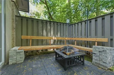 a backyard of a house with table and chairs