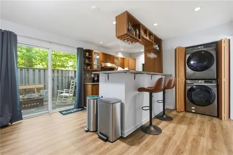 a view of a kitchen with a sink and wooden floor